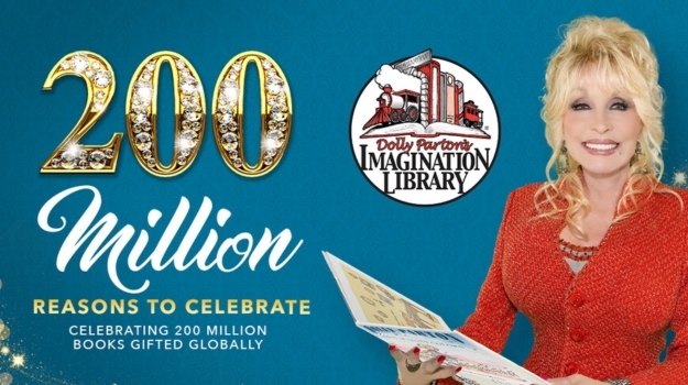 Dolly Parton holding an open children's book with the headline 200 million reasons to celebrate