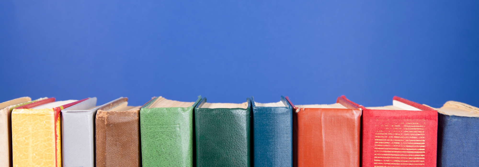 Row of books on blue background