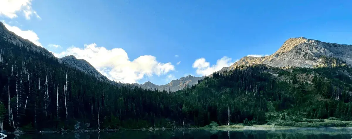 a mountain range over a lake