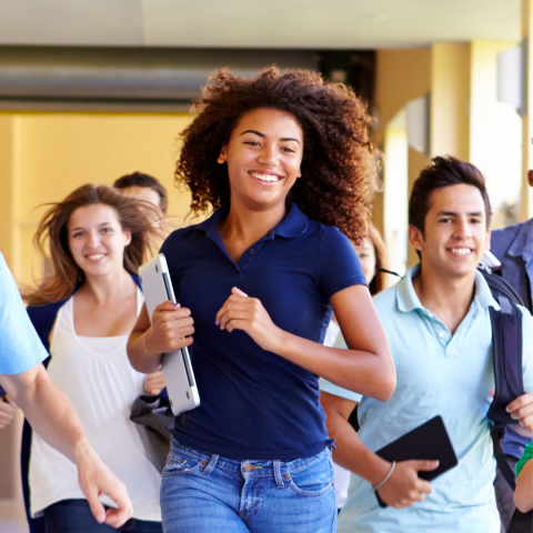 Teenagers running down a hallway