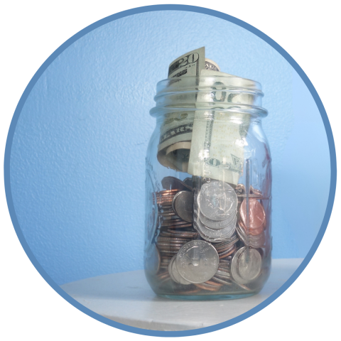 Glass jar full of change and dollar bills