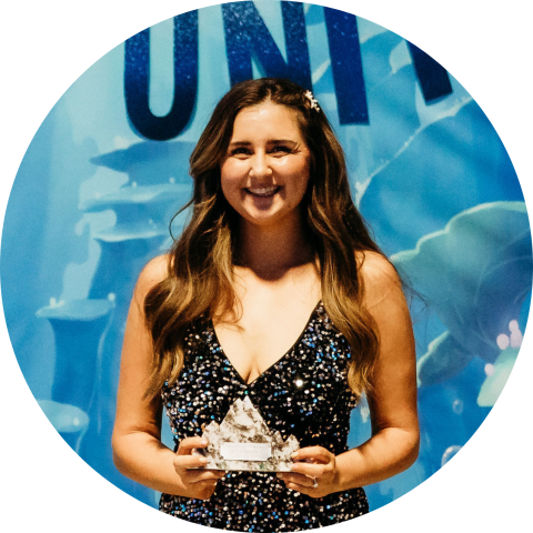 smiling woman holding award