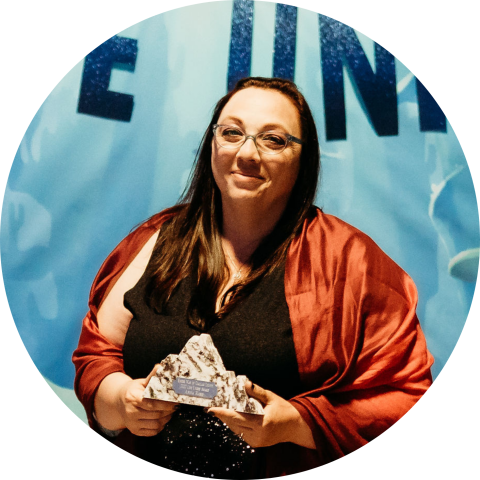 smiling woman holding award