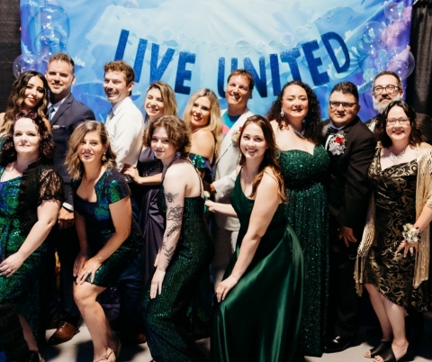 Group of people in formal wear posing for a phot