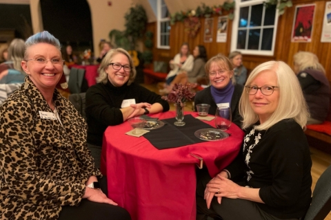 Group of women around a table at a cocktail party