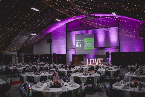 A large room full of tables set for a formal event