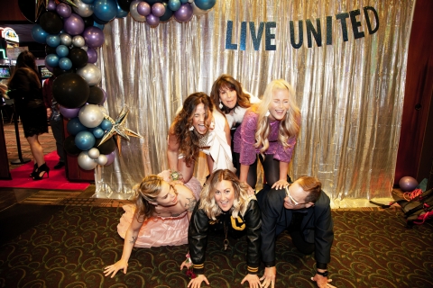 Human pyramid of people in fancy dress