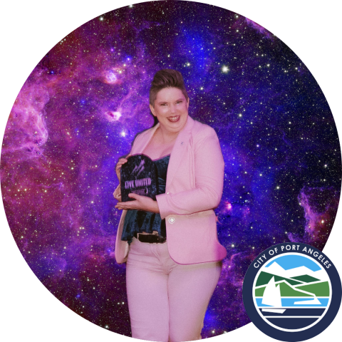 Circle image of woman in pink suit holding an award