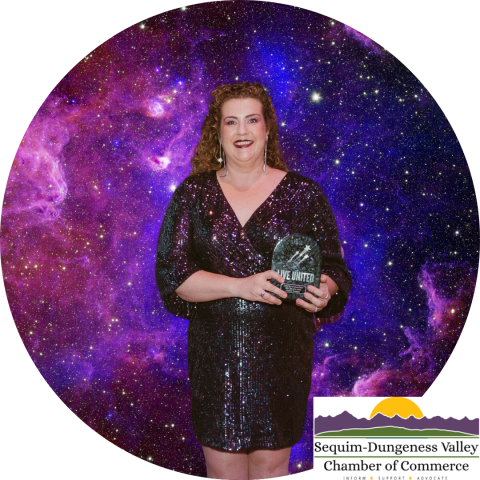 Woman holding award in front of space backdrop