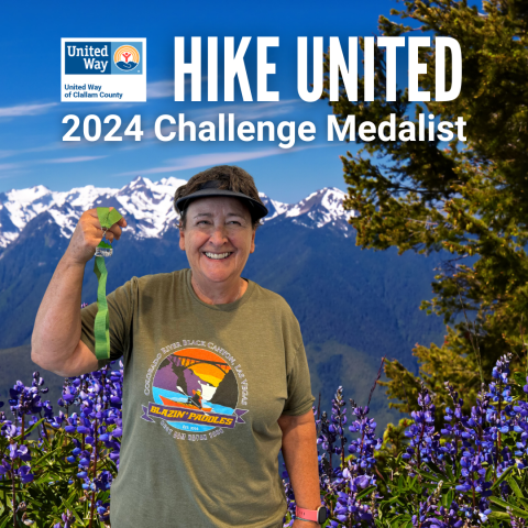Smiling woman holding a medal