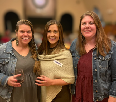 3 smiling women at a party