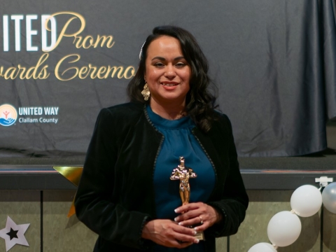 smiling woman holding award