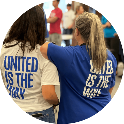 two women's back's in united way t-shirts