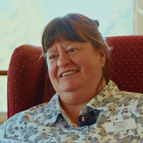 Woman sitting in red armchair