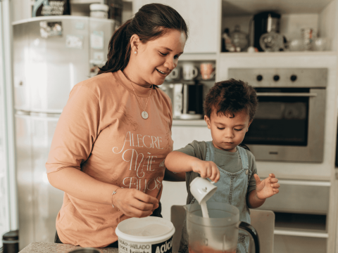 Mom and young son mixing ingredients