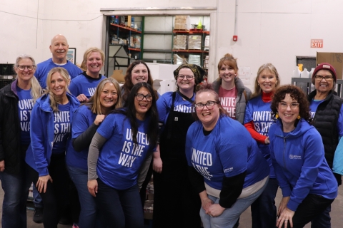 group of smiling people in a food bank