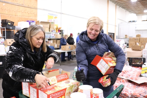 Two women working in a food bank