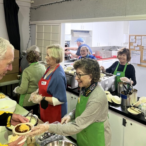 Group of older women working in a kitchen
