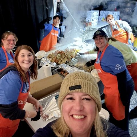 Smiling people working with steaming crab