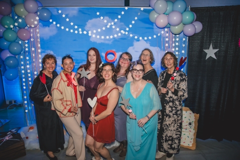 a group of smiling women all in different kinds of pajamas