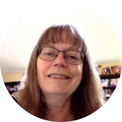 Smiling woman with glasses and bangs