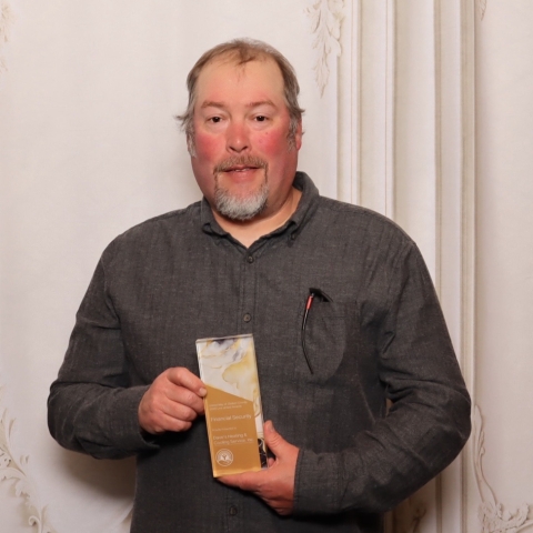 man holding an award