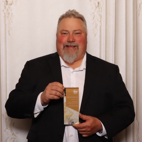 man holding award