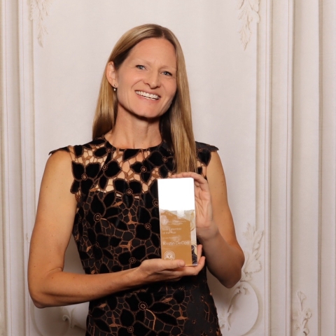 woman holding award
