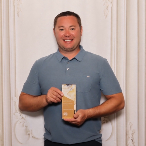 man holding award