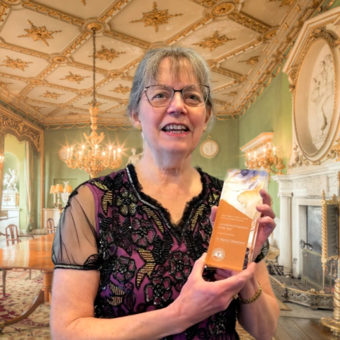 woman holding award