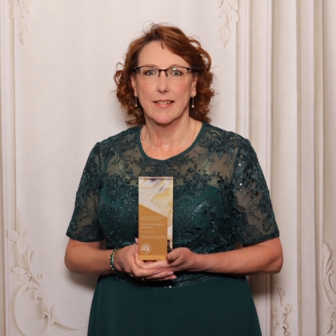 woman holding award