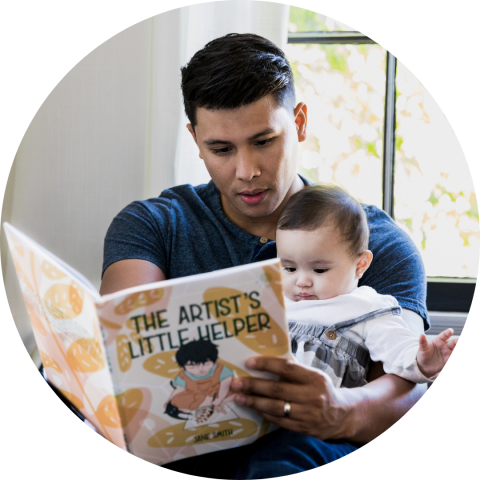 man reading to his baby