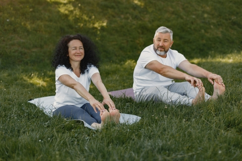 Man and woman stretching in the grass