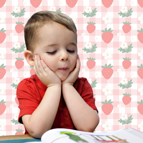 young boy looking at an open book