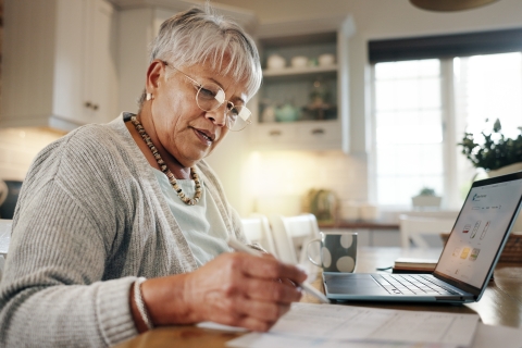 An older woman sitting at a laptop