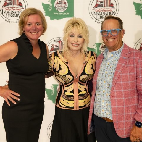 Dolly Parton posing for a photo with two other people