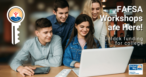 Young people gathered around a laptop
